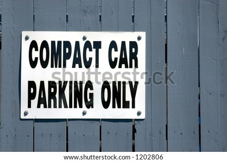 A sign reading COMPACT CAR PARKING ONLY.