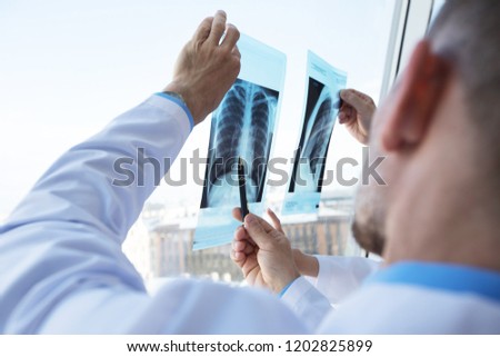 Healthcare, medical: Group of doctors discuss and looking x-ray in a clinic or hospital