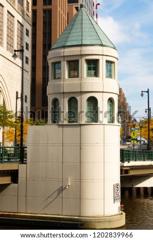 The "Wisconsin Avenue Bridge" tower with downtown Milwaukee,  Wisconsin in the background on a Autumn afternoon.