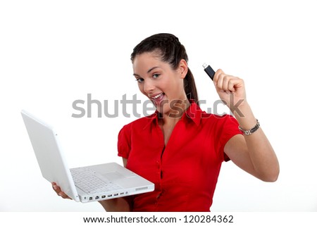 Woman holding laptop and USB key