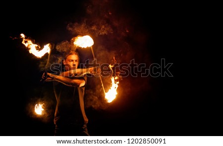 Fire show. Fire dancer dances with. Night performance. Dramatic portrait. Fire and smoke. Royalty-Free Stock Photo #1202850091