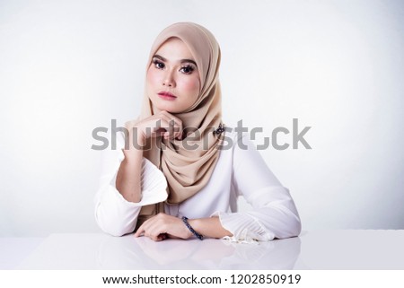 portrait of attractive young woman with hijab smiling to camera
