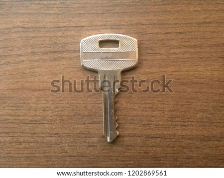 Small door lock key kept on wooden table