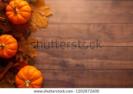 A Fall Themed Background on a Wooden Surface 
