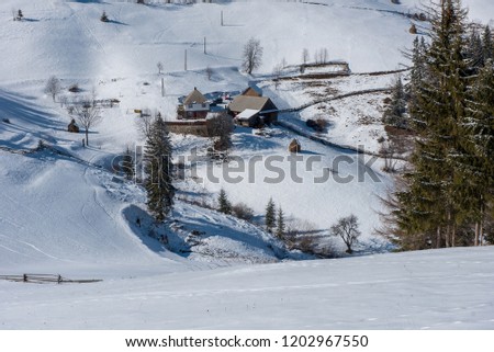 Winter mountain village landscape with snow covered houses