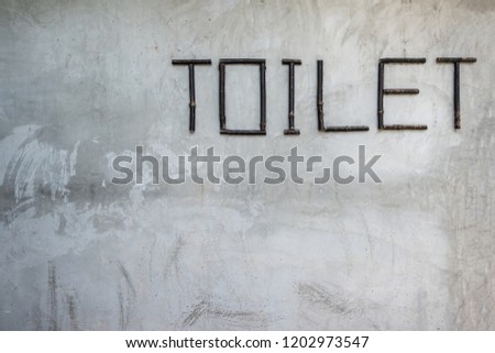 Close up textured raw of concrete wall with toilet sign background