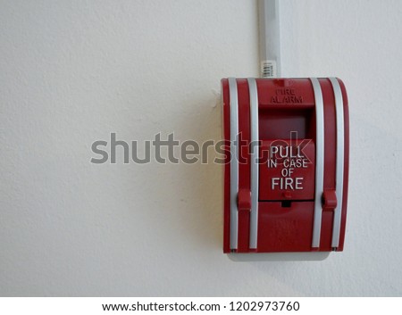 fire alarm emergency safety switch on the cement wall.
