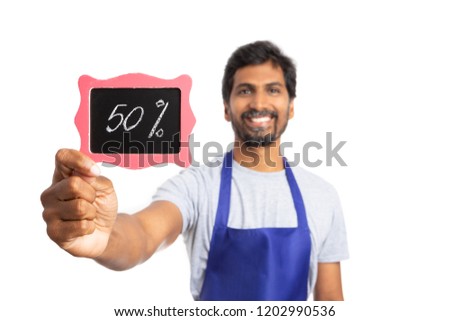 Focus on fifty percent discount sign held by indian hypermarket or supermarket employee as sales concept isolated on white