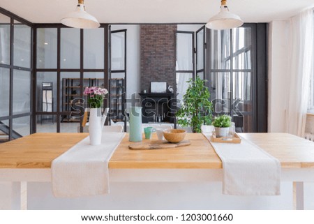 trendy modern design two-level 
apartment with large high windows. The stylish living room and kitchen in bright colors are undressed by a glass partition. bedroom on the second floor.
