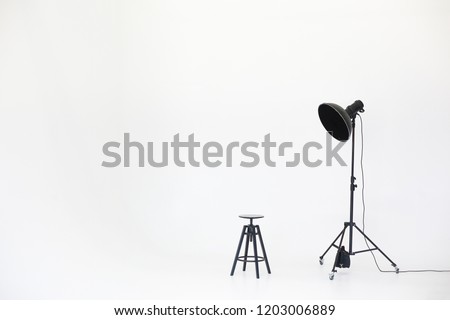 Wooden chair with lighting equipment isolated on a white background. Space for text. Vacant chair. The concept of selection and casting. Job recruitment advertisement.