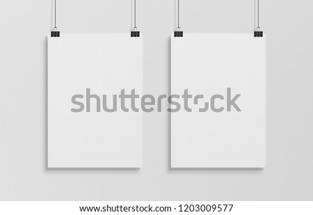Two blank white poster hanging up with in front of white wall clips mockup