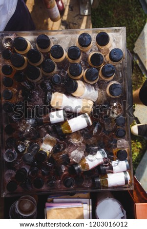 food photography / f&b - close up of bottle coffee kept in cooler filled with ice