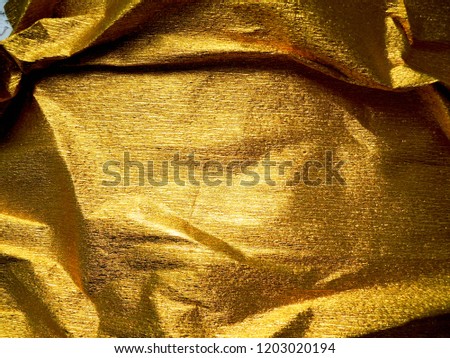 Shiny amazing background. Gold wrinkled paper texture abstract background. Holidays mood.  Background for graphic element, postcard. Space for your own text.