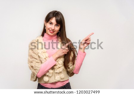 Studio photo of a beautiful brunette girl on a white background with different emotions. She is standing right in front of the camera in various poses, smiling and looking happy.