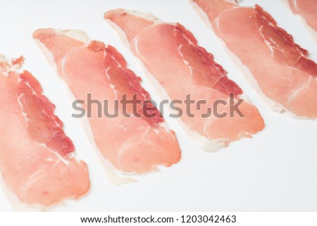 Raw bacon rashers isolated on white background