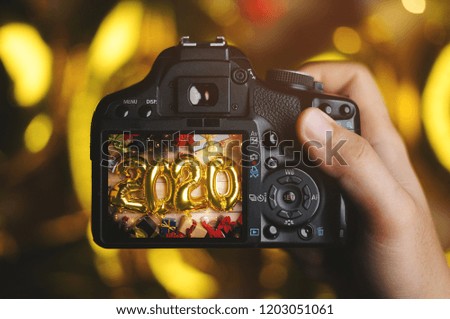 Taking Picture With Camera. 2020 Golden Balloon Between Christmas Decoration