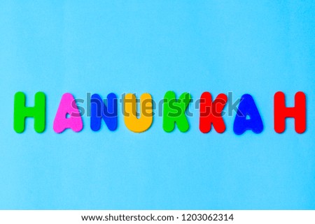 Happy Hanukkah colorful text on blue background.Jewish holiday  Chanukah greeting card.
