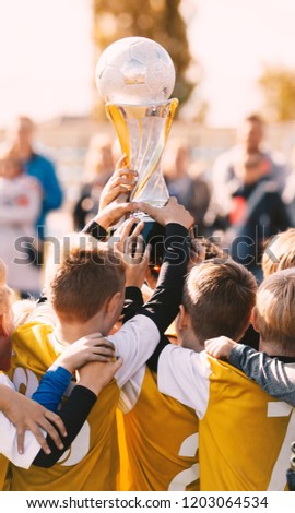 Soccer Champions. Young Sport Team with Trophy. Boys Celebrating Sports Achievement. Soccer Football Winning Moment