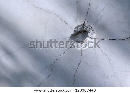 Bullet hole on the marble wall Royalty-Free Stock Photo #120309448