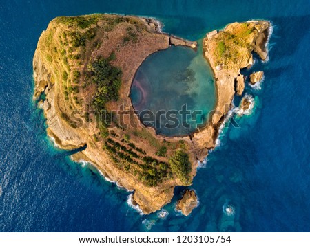 Top view of Islet of Vila Franca do Campo is formed by the crater of an old underwater volcano near San Miguel island, Azores, Portugal. Bird eye view, erial panoramic view. Royalty-Free Stock Photo #1203105754