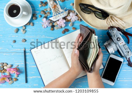 Wallet full of money for travel, concept of preparing to travel.