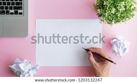 blank paper on pink background with laptop, idea thinking concept