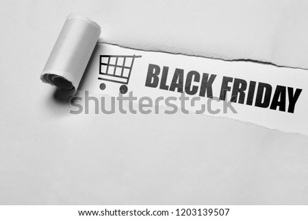 Black Friday message appering behind ripped paper. Black friday concept
