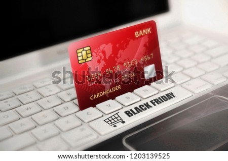 Red credit card with Black Friday text on laptop keyboard