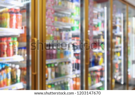 supermarket convenience store refrigerators with soft drink bottles on shelves abstract blur background Royalty-Free Stock Photo #1203147670