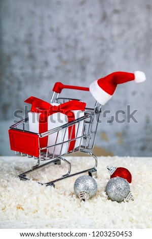 Christmas gift in a shopping cart on grunge background. Christmas sale.