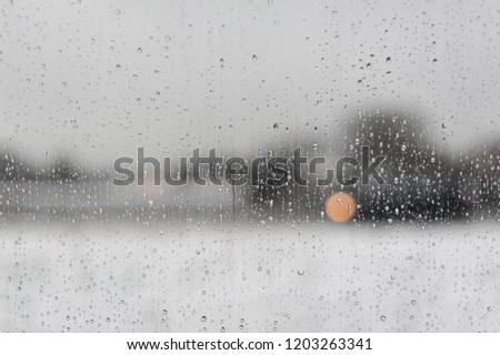 Water drops on a window with a black and white blurred background