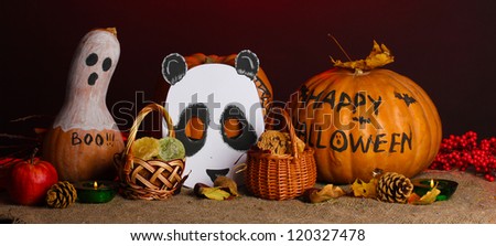 Trick or treat halloween masks and  buckets filled with cookies on color background