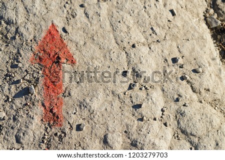 Red arrow on stone close-up