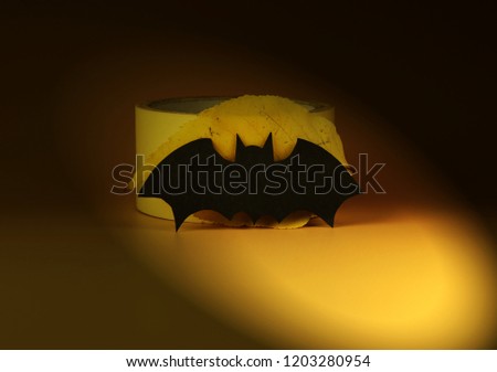 A black bat on yellow background. Black bat using on halloween party or decoration for your lands. Yellow background