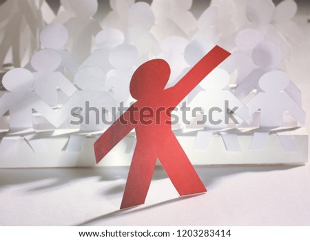 leader standing in front of a group of paper doll. photo with copy space