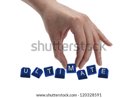 Concept shot of hand holding keyboard keys and spelling the word ultimate