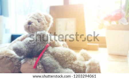 two bear dolls on wooden table.