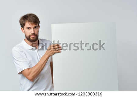 man holds white layouts in hand mockup, poster                               