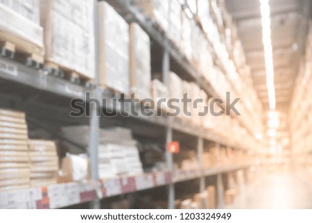 Blurred boxes on rows of shelves in warm light warehouse background.  Using for Mock up template for craft display of your design,Banner for advertise of product.