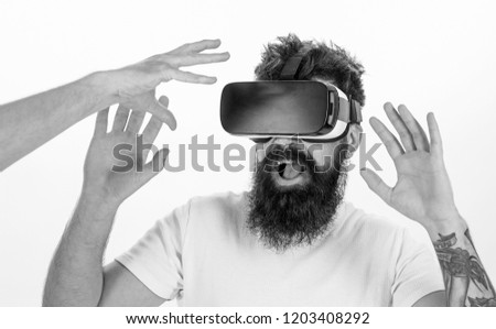 Man with beard in VR glasses, white background. Virtual reality concept. Hipster use modern technologies for entertainment. Guy with head mounted display interact with hand in virtual reality.