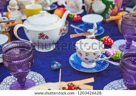 Tea party with cupcakes and different colorful cups