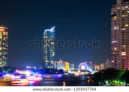 Cityscapes and Landmark of buildings at Night time along the Chao Phraya River. In Bangkok Thailand. It is a beautiful view to travel in holiday.
