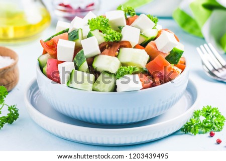 Cucumber feta tomato salad with olive oil dresssing. Selective focus, space for text.