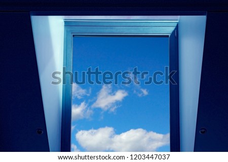 Bright sky with clouds visible through window in multilayer blue frame / aperture. Reworked photo of modern architecture fragment. Allusion to eco-friendly technologies or window of opportunity.