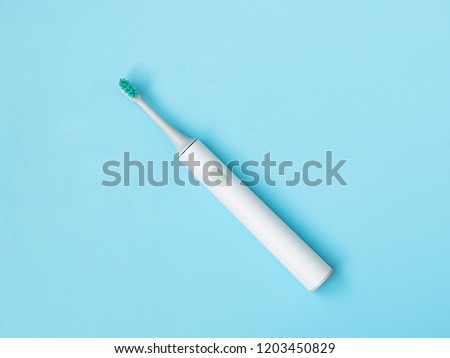Smart electric toothbrush. Charges through powerbank and is controlled by the application on the smartphone. Modern technology for health. Healthy teeth. Dentistry. Medical robot. Royalty-Free Stock Photo #1203450829