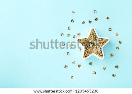 Round colorful sequins in star shape on blue background