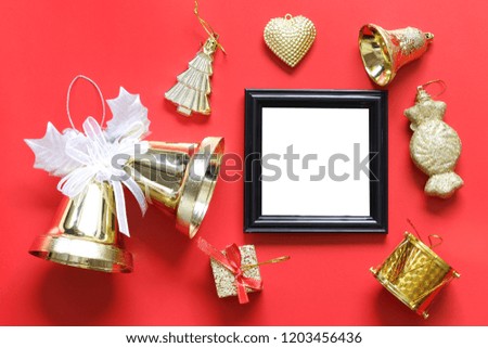 Empty black photo frame and christmas decoration on red background for design in your work concept.