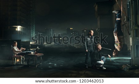 Gangsters caught the debtor on the street.Man hanging on a rope. Royalty-Free Stock Photo #1203462013