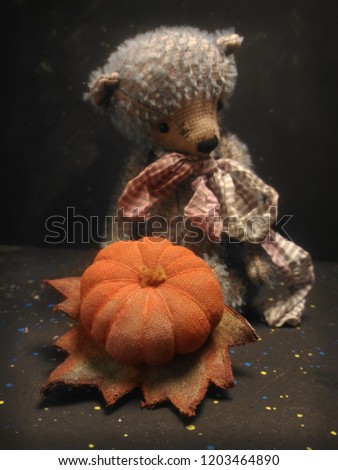 pumpkin bear toy hellovin dark background. vintage card
