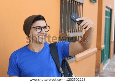 Young hip male taking a selfie 